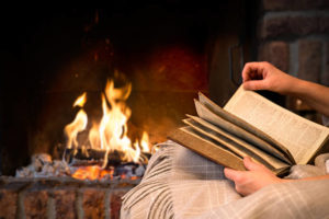 Hands Of Woman Reading Book By Fireplace La Poire Porrentruy